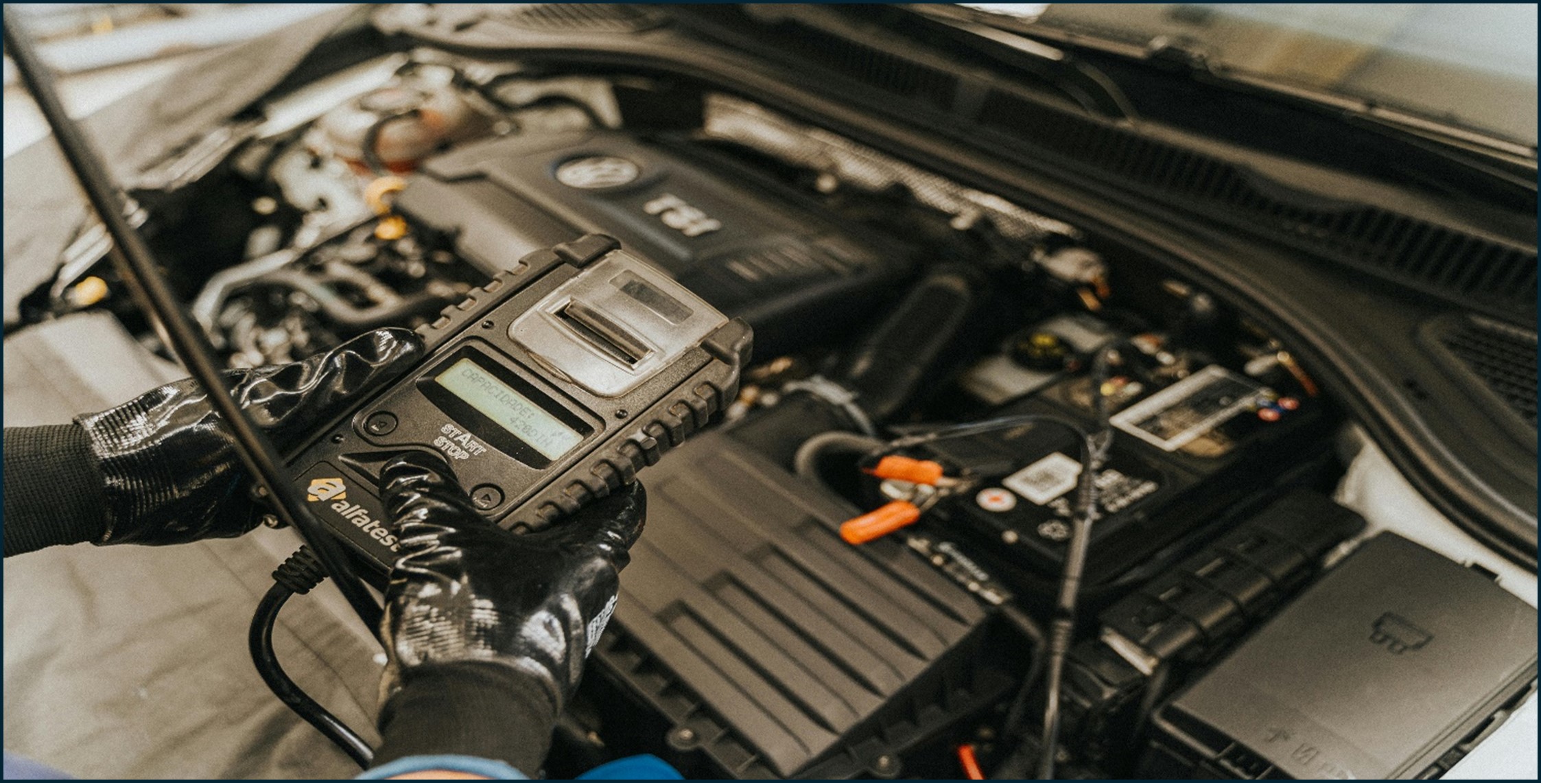Auto technician inspecting and repairing a car under the hood - Essential Vehicle Checkup Tips