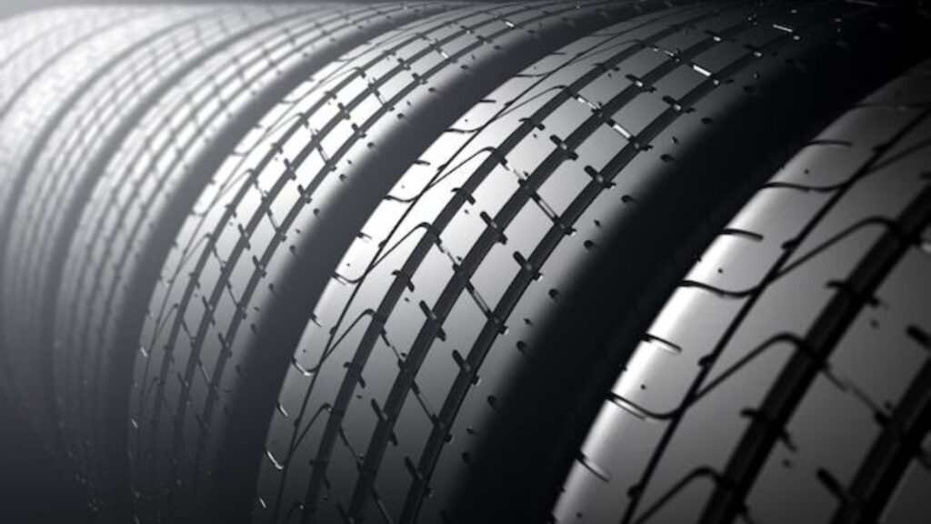 Close-up of all-season tires with detailed tread patterns designed for durability and optimal traction on the road.