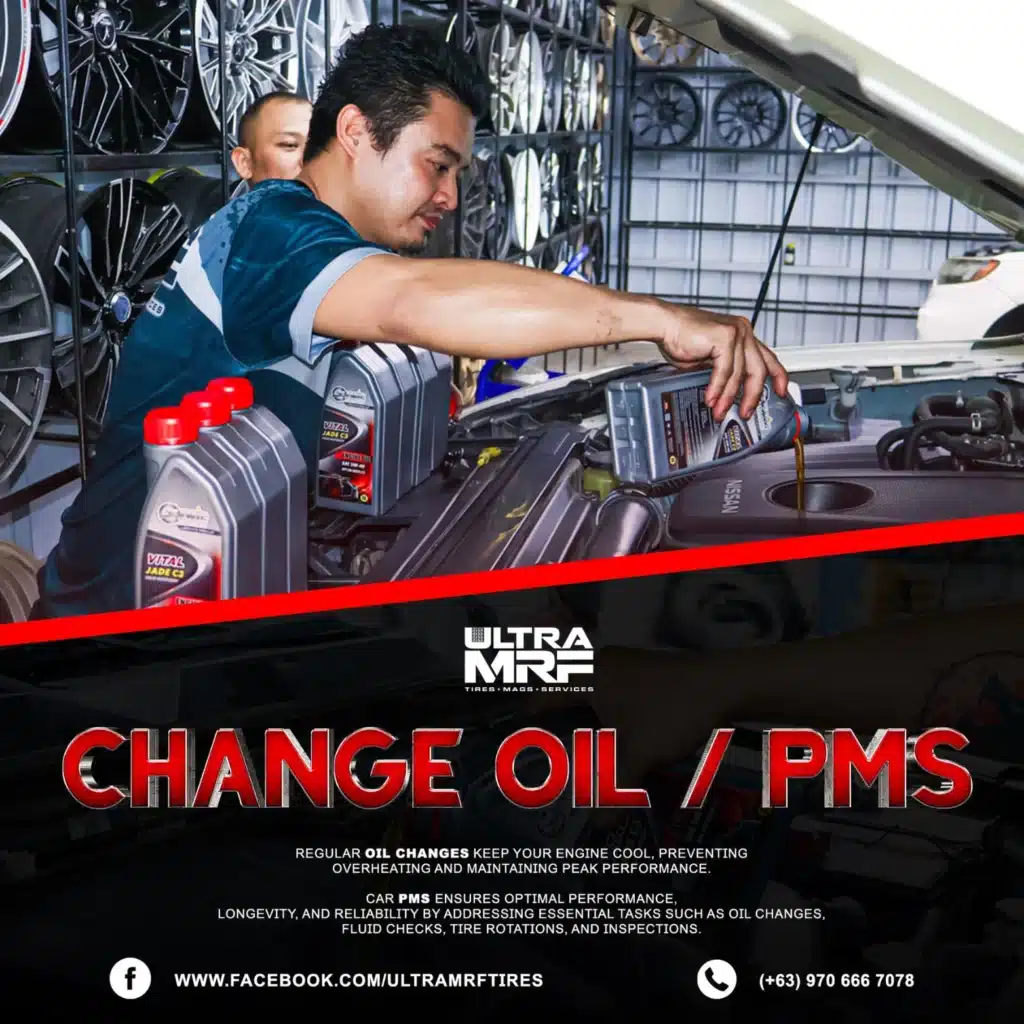 Professional Car Care Solutions A mechanic pours engine oil into a car’s engine bay at an auto shop, with oil containers and alloy wheels