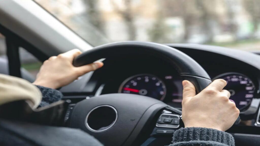 A close-up of a car's handle grip steering wheel with a sleek, ergonomic design for better control and comfort.